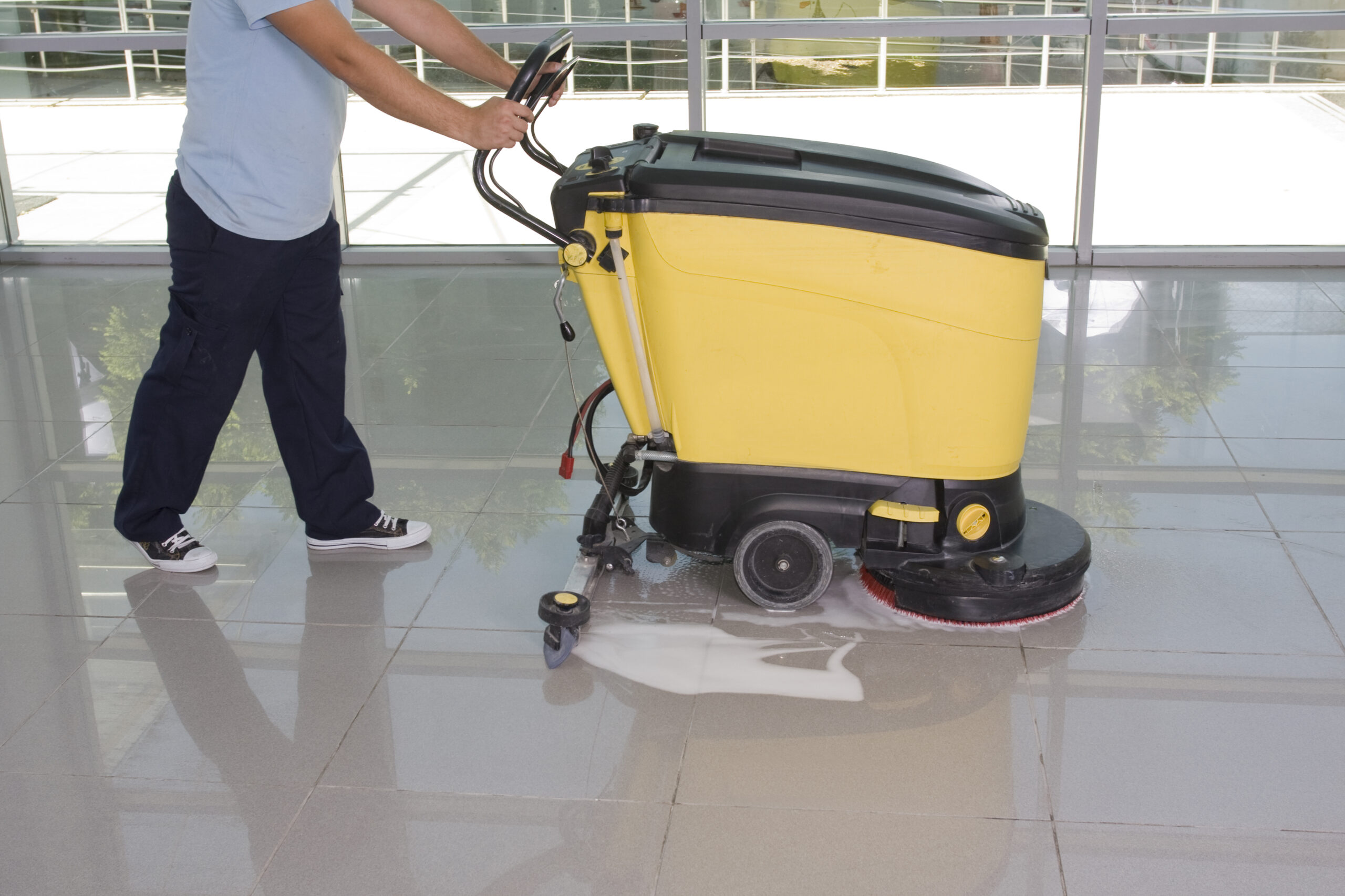 A Man worker cleaning the floor with scrubber machine. image. High quality photo